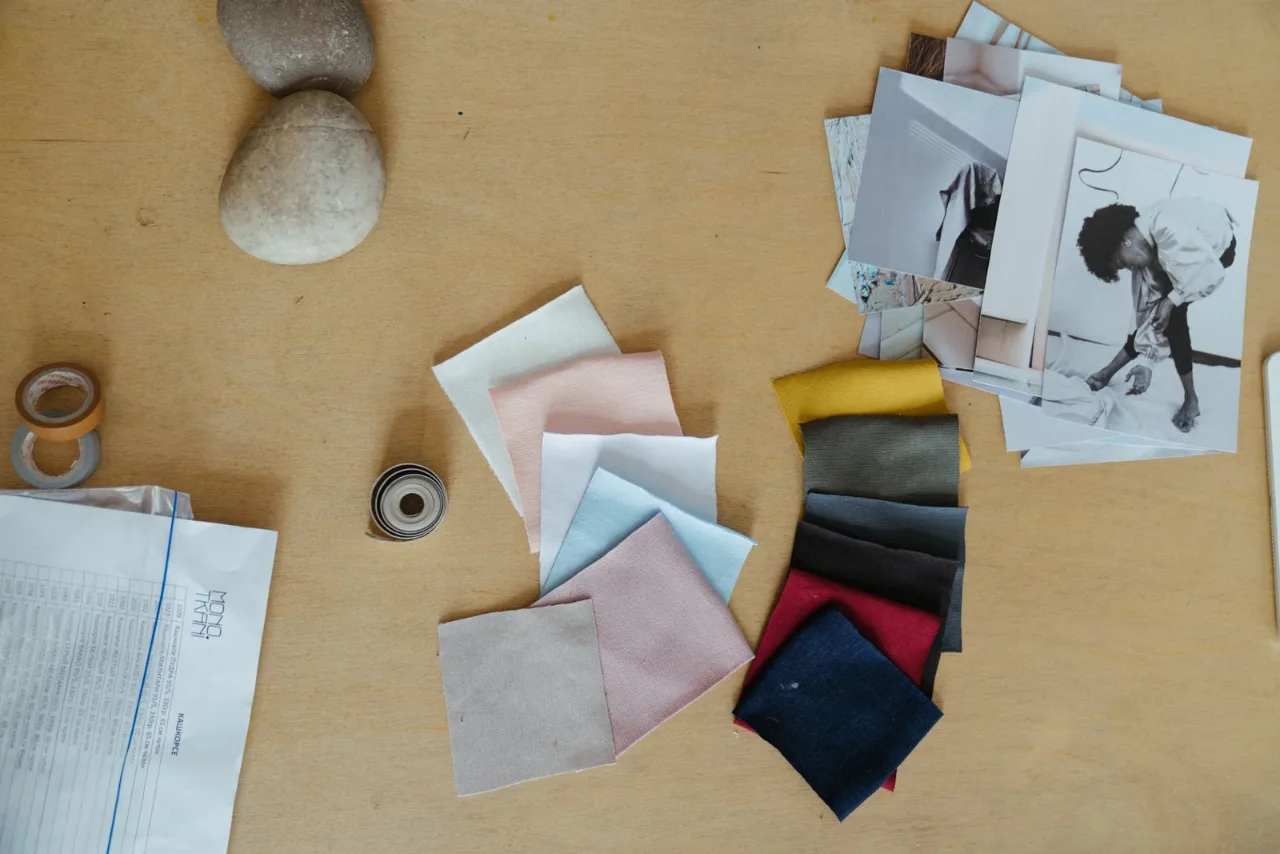 Fabric swatches and brand references laid out for a clothing identity